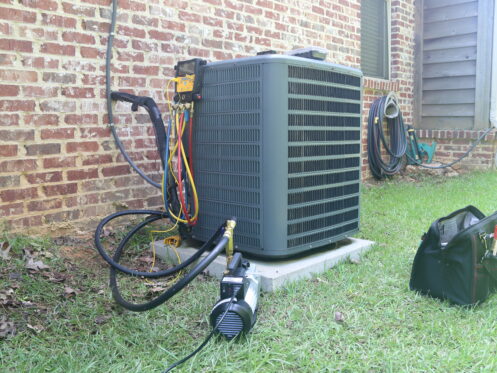 An AC unit getting maintenance in Mokena
